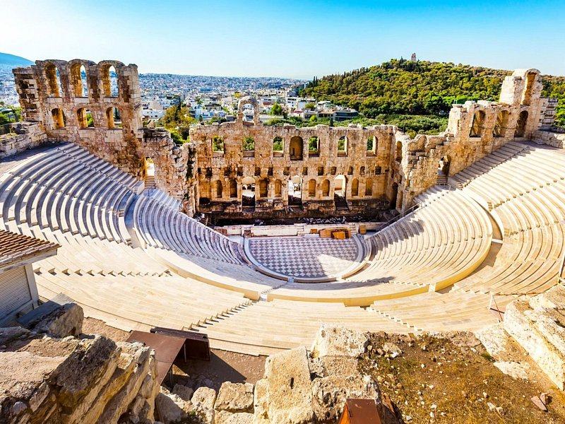 The Odeon of Herodes Atticus on the south slope, its marble seating curving below the arched wall
