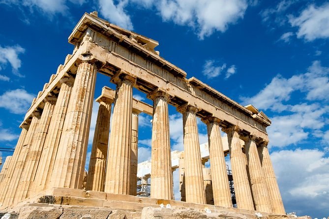 The Doric columns and entablature of the Parthenon seen from below against a blue sky